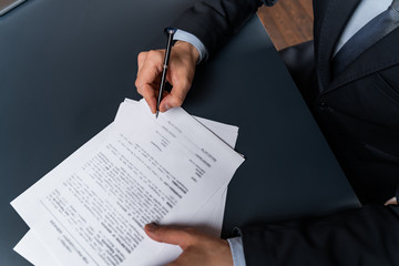 A man signing contract at the office. The concept of entering into partnership.