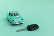 Toy car with key  on a menthol background  