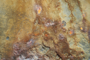 Martian rocky surface of the red planet, with different shades of color and rust marks in the background