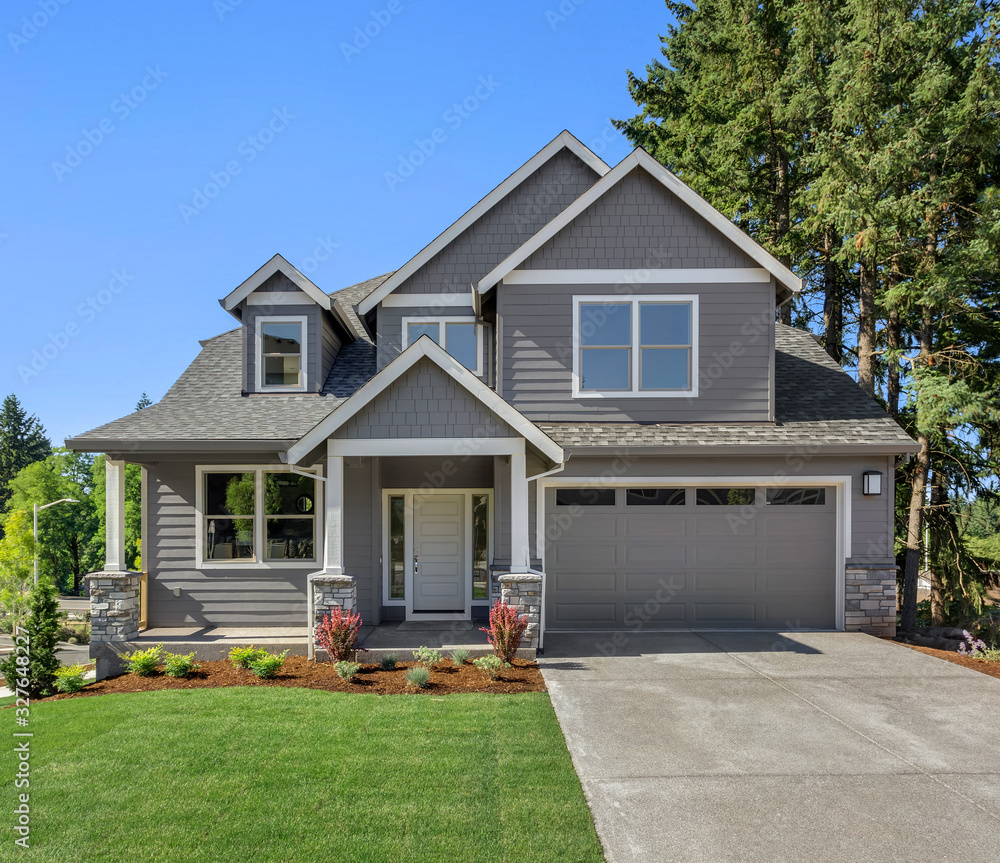 Suburban home exterior on bright sunny day, with large yard and covered porch - obrazy, fototapety, plakaty 