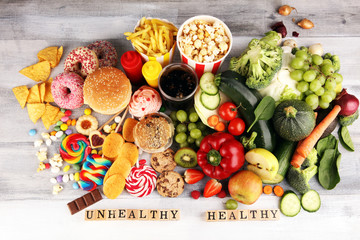 Wall Mural - healthy or unhealthy food. Concept photo of healthy and unhealthy food. Fruits and vegetables vs donuts,sweets and burgers