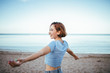 © Dani - Happy young girl short hair on the beach dressed with blue t-shirt