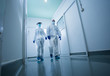Biologist in protective clothing in laboratory hallway