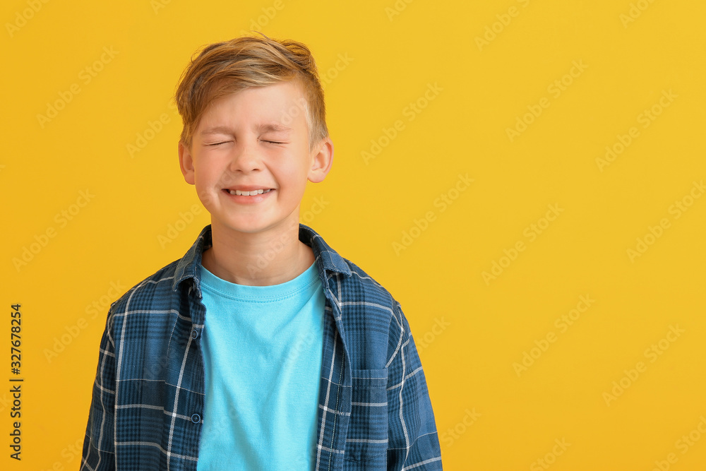 Happy little boy with healthy teeth on color background