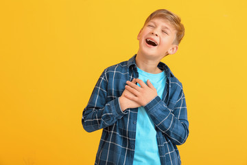 Wall Mural - Happy little boy with healthy teeth on color background