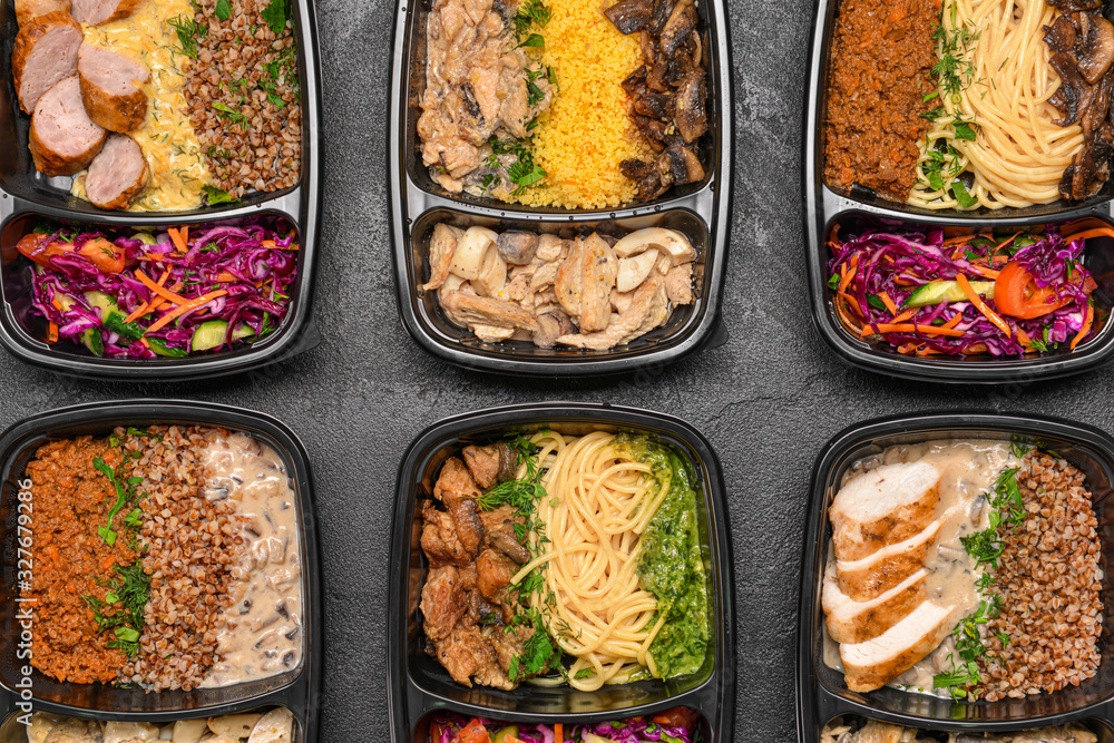 Containers with healthy food on dark background