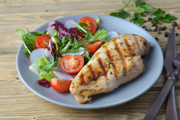 Wall Mural - grilled chicken fillet with vegetable salad