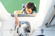 © Sarah Rypma - Young Girl in a life jacket climbing into boat with her wet puppy