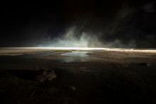 Abstract Mars Like Terrain With Muddy Puddles Of Water Textures, Rocks And Heavy Fog Rolling Through Night Background. Mars, Moon, Other World Or Doomed Concepts