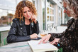 © goodmanphoto - Two women having a business meeting outdoors