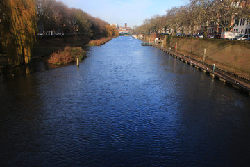 Wall Mural - Large river  within the city den bosch of the netherlands wthat still harbours a lot of large boats