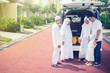 © Creativa Images - Happy muslim Malaysian Multi-generation family standing behind a car