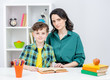 © Ermolaev Alexandr - Portrait of a mother and her son doing homework together at home