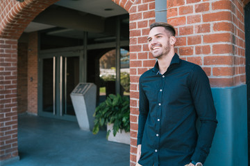 Wall Mural - Portrait of young man with urban background.