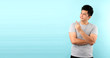 Portrait of handsome,Shock and surprise face of asian man Pointing finger on empty space isolated on blue background in studio With copy space.