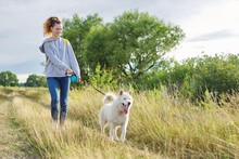 Active Healthy Lifestyle, Teen Girl Walking With White Husky Dog