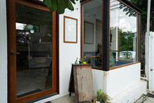 Exterior Architecture And Building Design Of Coffee Cafe And Bakery Shop Decorated With Wooden Mirror Glass Frame And Green Plants