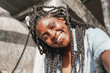 © olezzo - Happy young beautiful african american woman with pigtails and a piercing on her face makes selfie, beautiful smilling happiness and joy