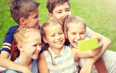 Sticker - friendship, childhood, technology and people concept - group of happy kids or friends taking selfie by smartphone in summer park