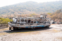 Old, Weathered Abandoned Boat Sits In A Marsh At Low Tide On Elephanta Island In Mumbi, India