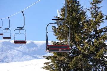 Empty chairlift at mountain ski resort. Winter vacation