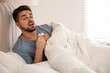 © New Africa - Sick young man in bed at home. Influenza virus