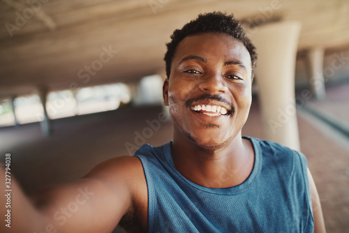 Fotografía Portrait of a smiling young african american man taking selfie after jogging at