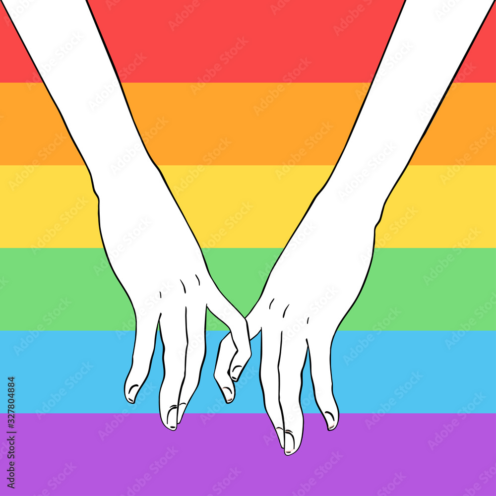 Two women holding hands over gay community rainbow colored flag ...