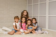 © producer - Group of kid sitting on floor together. four little girls have fun . friendship concept