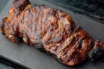 Steak. Grade A, grass fed angus beef. Traditional classic New York steakhouse menu favorite. T-bone steak, bone in, cooked to medium to rare and sliced. 