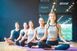© Kawee - Group of Multi ethics people learning Yoga class in fitness club. Female Caucasian instructor leading Meditate sitting Yoga pose, students follow behind. Yoga for health, wellness and sport concept.