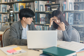 High school or college students  group catching up workbook and learning tutoring on desk and reading, doing homework, lesson practice preparing exam.