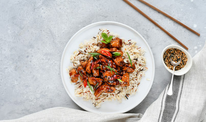 Wall Mural - spicy chicken teriyaki with rice. asian food. Chinese cuisine, Thai cuisine. Japanese food, copy space, recipe background, food flat lay