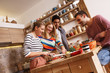 © BalanceFormCreative - Group of friends preparing vegetarian meal.They preparing food and making fun in the kitchen.