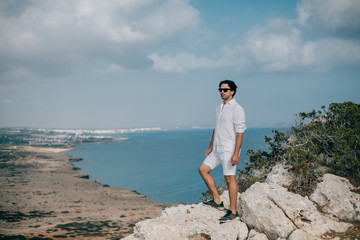 Wall Mural - A man on the rocks overlooking the sea