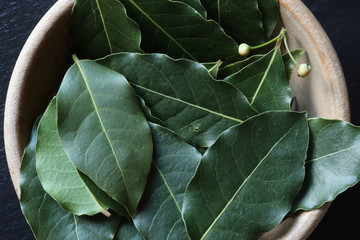 Photography of laurel leave in a wooden bowl for food background