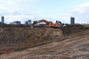 Wall Mural - Group of the excavators for dig ground trenching at a construction site for foundation and installing storm pipes. Backhoe digging for pipeline ditch. Commercial and Public Civil Work Contractor