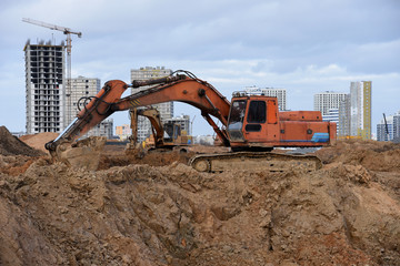 Wall Mural - Group of the excavators for dig ground trenching at a construction site for foundation and installing storm pipes. Backhoe digging for pipeline ditch. Commercial and Public Civil Work Contractor