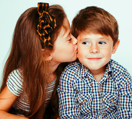 little cute boy and girl hugging playing on white background, happy smiling family, lifestyle people concept close up