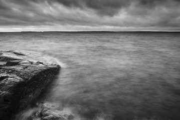 Wall Mural - Long exposure Black and white photo of cliffs and lake