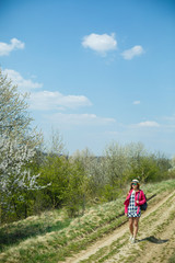 Wall Mural - beautiful girl in a dress walking in the spring forest where the trees bloom