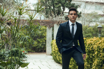 Sticker - Young boy with suit walking through garden