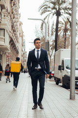 Wall Mural - boy walking in town with suit