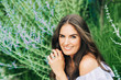 © annanahabed - Outdoor close up portrait of pretty young woman with dark hair posing in summer garden with purple flowers