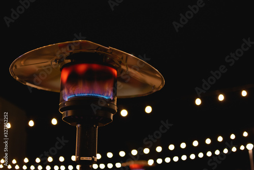 Fotomural Heater / Flame Tower Close up at night, with bokeh effect background