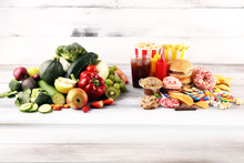 Healthy Or Unhealthy Food. Concept Photo Of Healthy And Unhealthy Food. Fruits And Vegetables Vs Donuts,sweets And Burgers