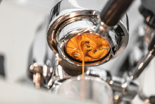 Coffee Machine Espresso Extraction Pouring From Bottomless Naked Portafilter. Professional Equipment At Home Or Cafe Shop. Closeup Of Brown Crema.