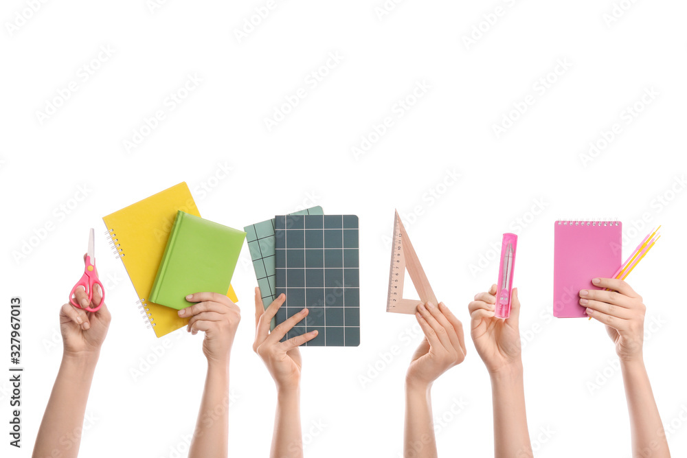 Many hands with school supplies on white background