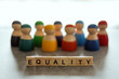 © Farknot Architect - EQUALITY word on wooden blocks with diverse people in the background