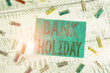 Writing note showing Bank Holiday. Business concept for A day on which banks are officially closed as a public holiday Colored clothespin rectangle square shaped paper white wood background